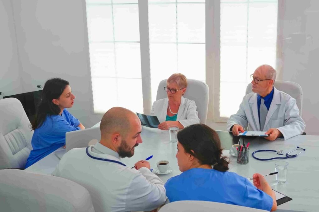 Healthcare professionals discussing patient records and datas through Hospital Management System