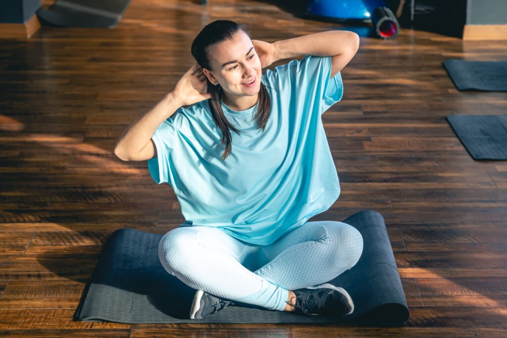Person performing stretching exercises for upper back and neck pain to relieve muscle tension and improve flexibility.